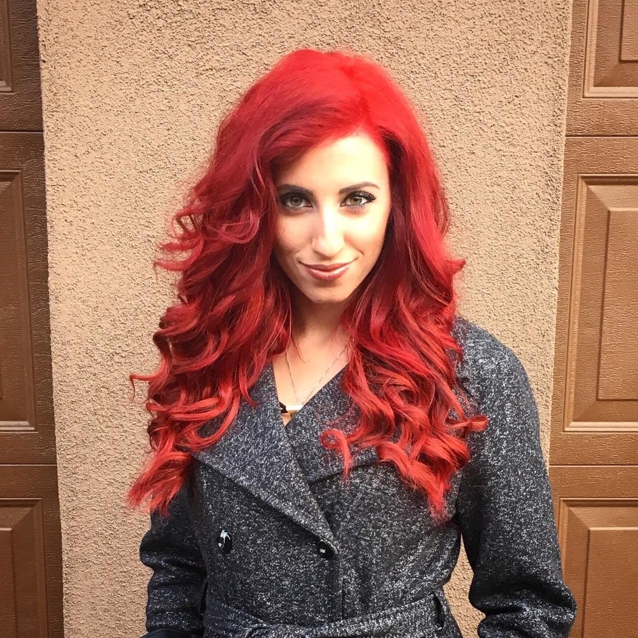 Client with long red hair styled in layered, defined curls
